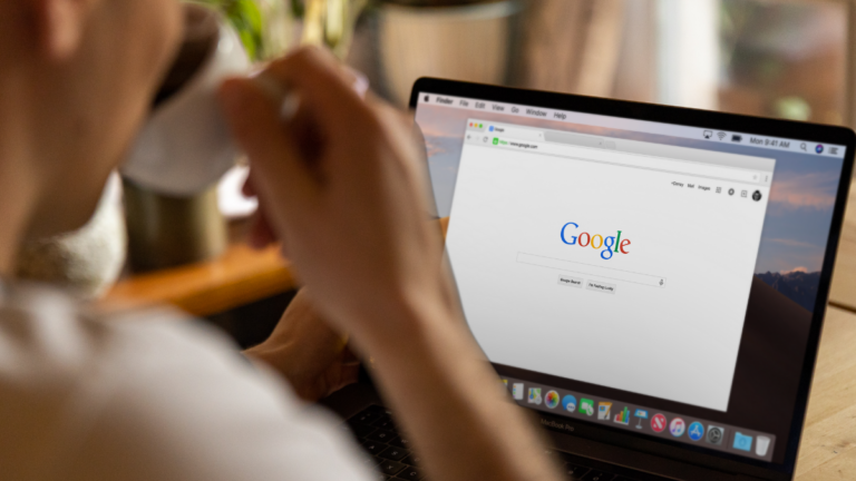 Person using a laptop with Google open on the screen, symbolizing the impact of SEO on manufacturing business growth.